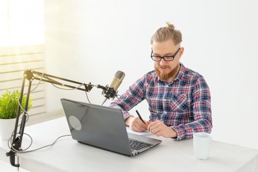 Radio host concept - Handsome man working as radio host at radio station
