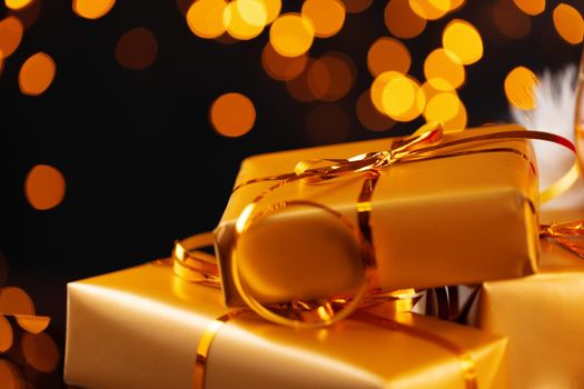 Wrapped Christmas gifts on golden lights bokeh background