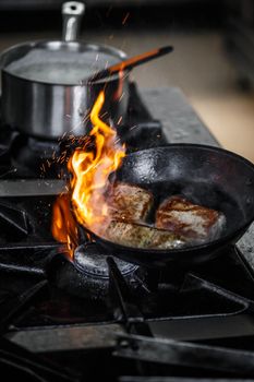 Chef frying pork meat