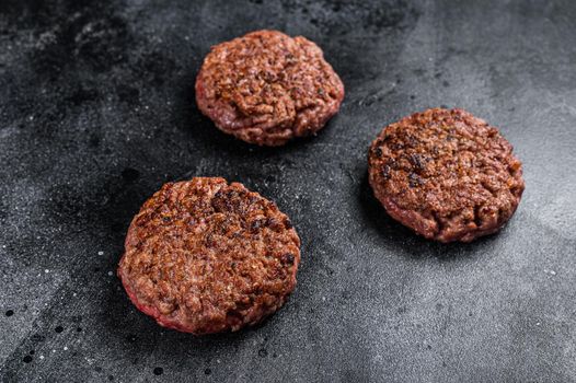 Grilled ground beef steak patties for burgers, Mince meat. Black background. Top view