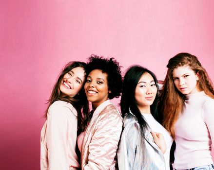 different nation girls with diversuty in skin, hair. Asian, scandinavian, african american cheerful emotional posing on pink background, woman day celebration, lifestyle people concept