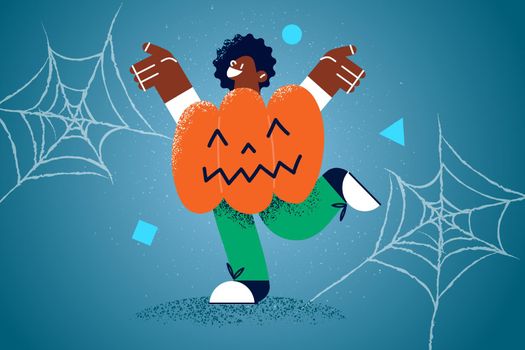 Happy ethnic kid in pumpkin costume celebrate Halloween