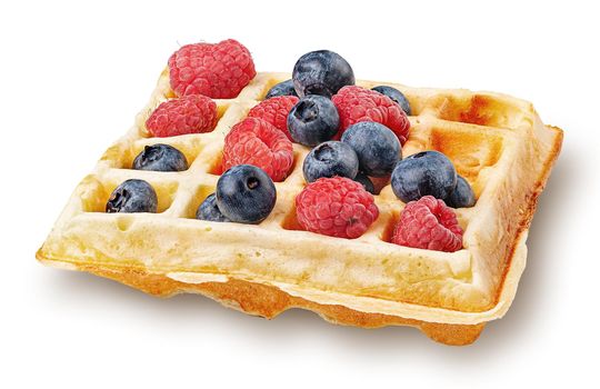 French waffle with berries isolated on white