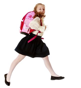 Little girl with backpack and runs to school.