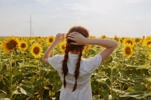 woman with two pigtails in a field of sunflowers countryside. High quality photo