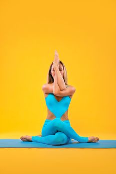 Portrait of a beautiful young woman sitting in yoga pose
