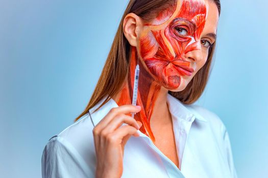 Cosmetic injection in the face. Young woman with half of face with muscles structure under skin. Model for medical training on a light background.
