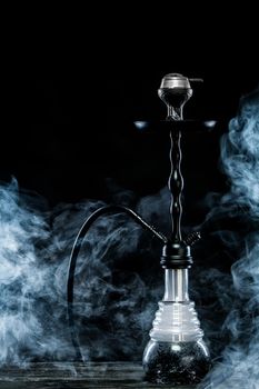 Hookah hot coals on bowl with black background. Stylish oriental shisha. Concept for bars and night clubs