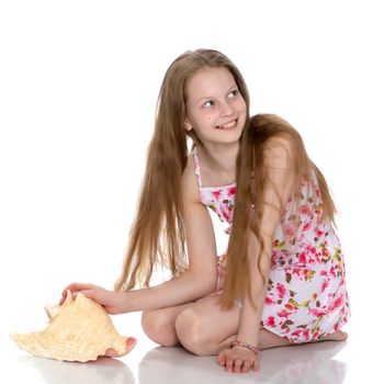 Teenage girl with seashell