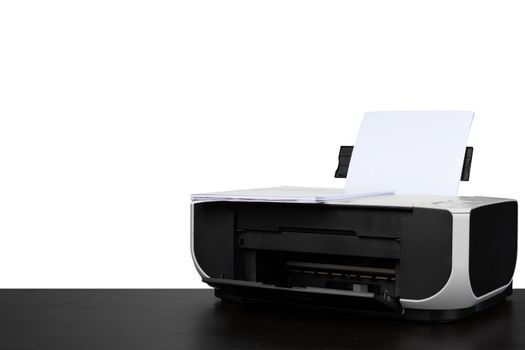 Laser home printer on table against white backgorund