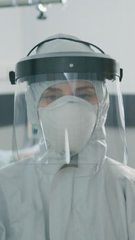 Portrait of woman with protective suit against coronavirus