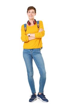 Full length happy young woman standing with bag and headphones on isolated white background
