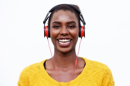 cool african american woman listening to music with headphones