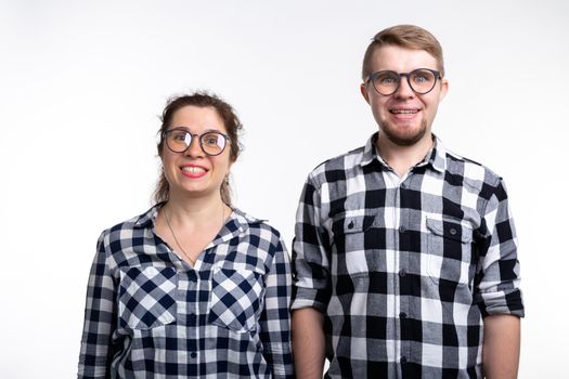 People, geek and education concept - Two students with funny faces over white background