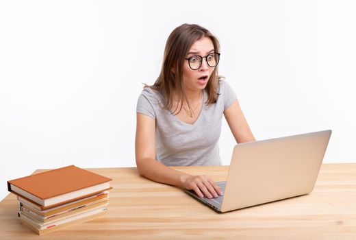 Study, education and people concept - young surprised woman nerd is learning exercises using laptop