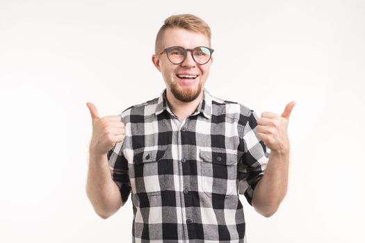 Student, geek, nerd and education concept - Smiling man in plaid shirt gesturing thumbs up over white background