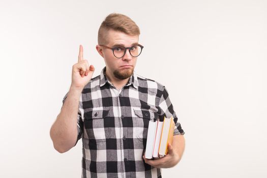 Geek, nerd and education concept - Handsome man in plaid shirt finger gesture up over white background