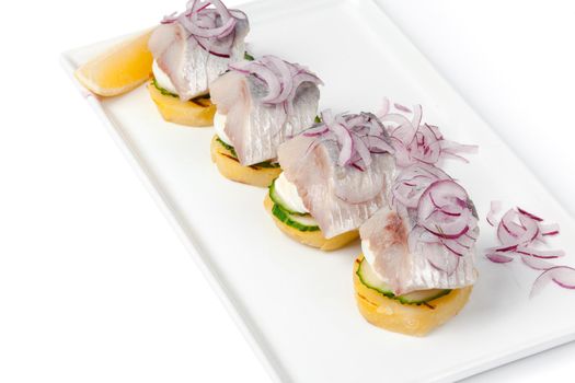 Toasts with herring appetizer on white background