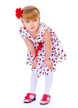 Cheerful little girl with red rose, braided hair, joking in the studio.