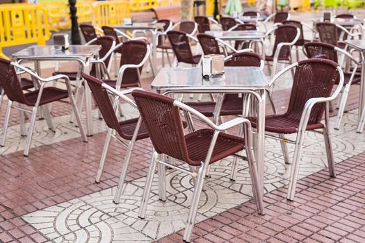 Cafe, coffee shop, tavern and restaurant concept - Outdoor street cafe tables ready for service.