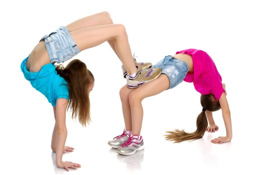 Girls gymnasts perform exercises.