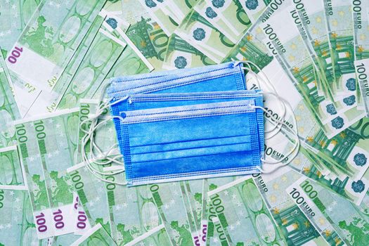 Protective face masks on background of Euro banknotes