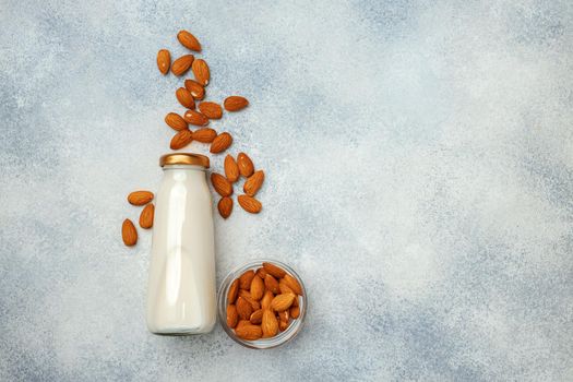 Flatlay with glass bottle of nut milk and nuts top view