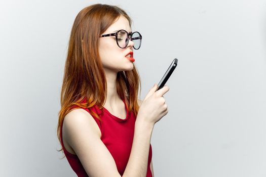 pretty woman in glasses with phone in hands communication technology. High quality photo