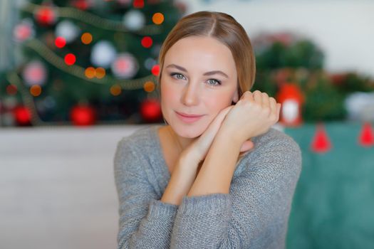 Beautiful Woman near Christmas Tree