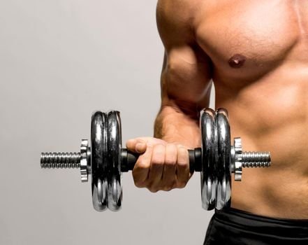 powerful muscular man lifting weights