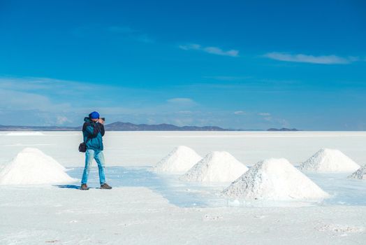 Man taking photos of salt banks in Salar de Uyuni