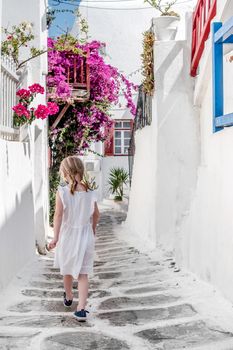 Little girl walking the narrow alley in Greece