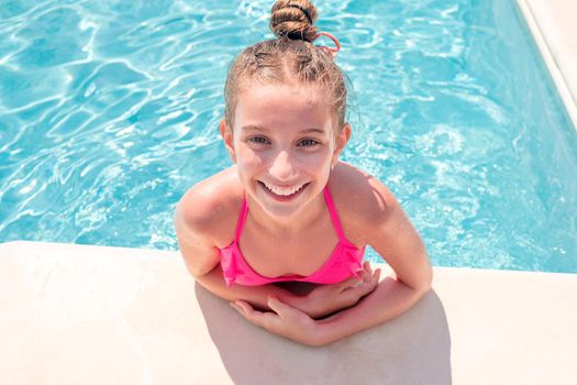 Teen girl in swimming pool squinting her eyes
