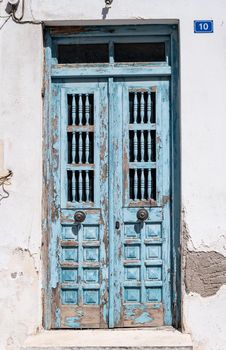 Vintage blue wooden door with cracked paint