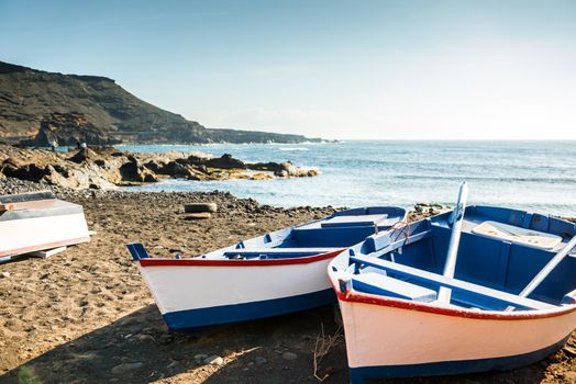 painted fishing boats on Canary Island shore in bay