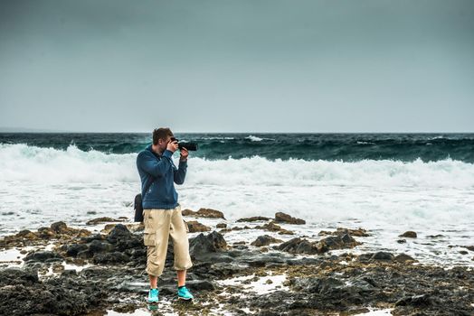 man taking photo on Lanzarote seashore