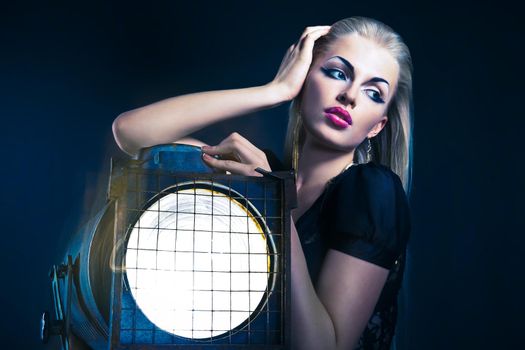 Sexy young woman with old floodlight