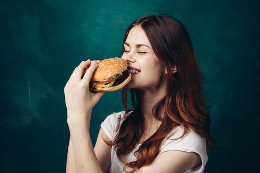 cheerful woman eating hamburger snack close-up lifestyle