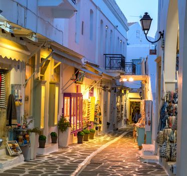 Touristic narrow street with souvenirs shops in the evening