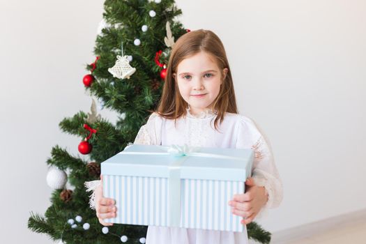 Holidays, presents, christmas, x-mas concept - happy child girl with gift box.