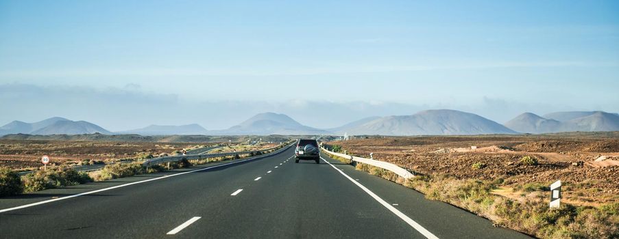 car driving away to mountains in Canary Island desert