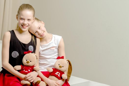 Two cute little girls close-up, in the studio. The concept of a happy childhood, Beauty and fashion.
