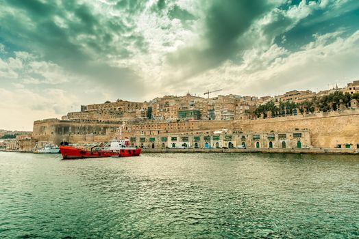 picturesque view of Valletta embankment with ship from the sea