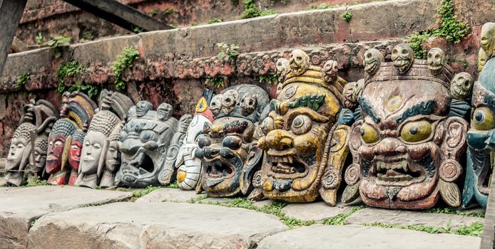 Nepalese traditional demon mask under the wall, Kathmandu, Nepal