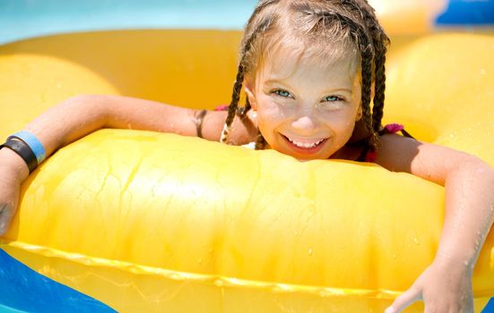 Little girl sitting on inflatable ring
