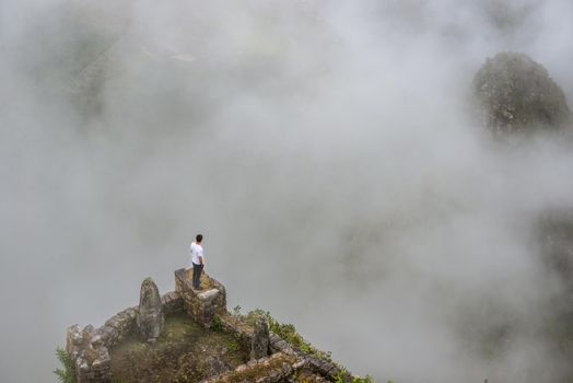 Man standing on the edge of mountain