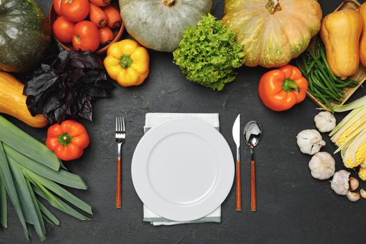 Tableware surrounded by variety of vegetables top view