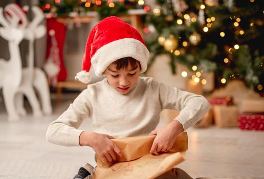 Little boy rolling letter to santa