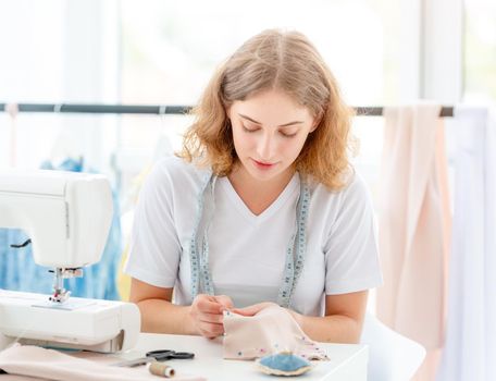 Dressmaker sewing new design by hands