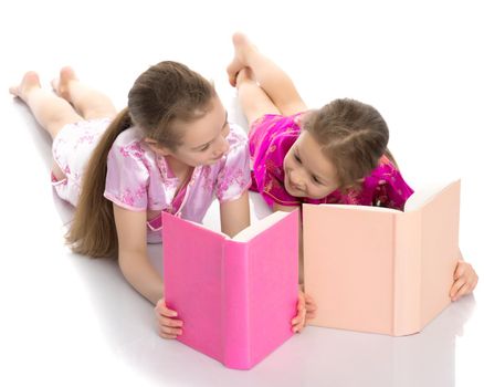 Sister girls read a book.